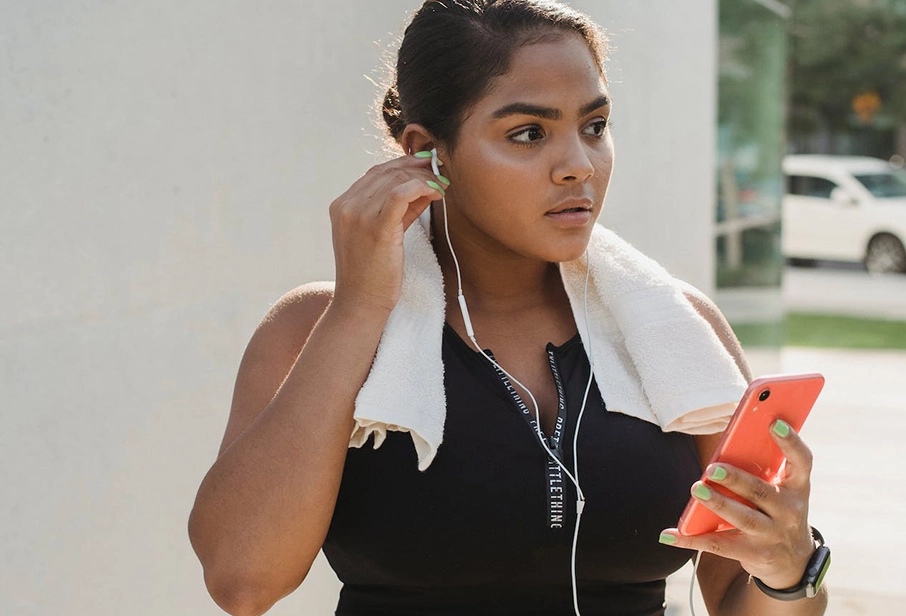 Young hispanic woman with headphones and a smartphone