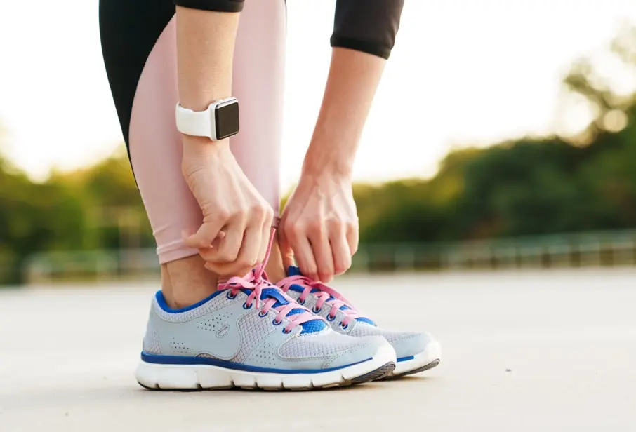 A person exercising outdoors wearing a sports watch